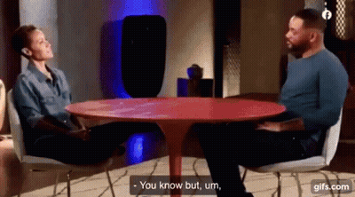 Man And Woman Talking At Red Table GIF