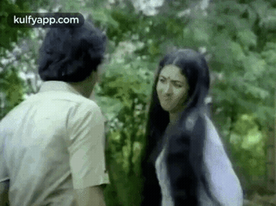 Man And Woman Talking In Woods GIF