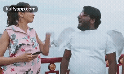 Man And Woman Talking On Balcony GIF