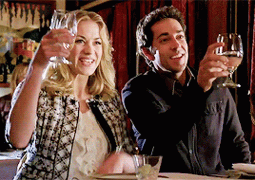 Man And Woman Toasting With Wine Glasses In Restaurant GIF