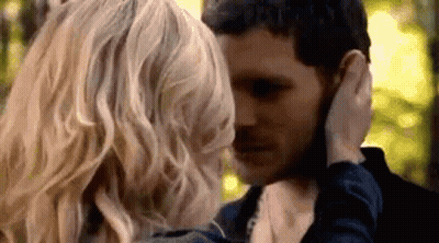 Man And Woman Touching Faces In Forest GIF