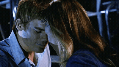 Man And Woman Touching Foreheads In Dark Room GIF