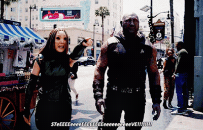 Man And Woman Walking By Hollywood Sign GIF