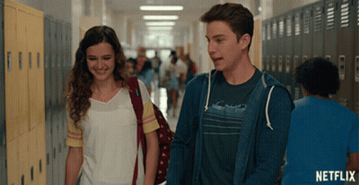 Man and Woman Walking Down Hallway With Netflix