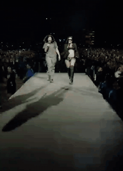 Man And Woman Walking Down Runway GIF
