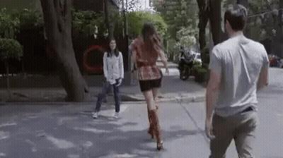 Man And Woman Walking Down Street GIF