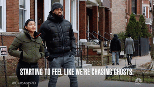 Man And Woman Walking Down Street Chasing Ghosts GIF