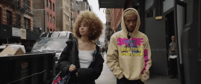 Man And Woman Walking Down Street Wearing Hoodie Saying Reality GIF
