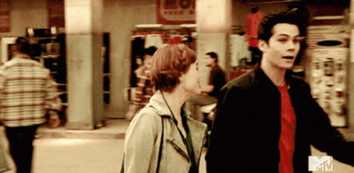 Man And Woman Walking Down Street With MTV Logo GIF