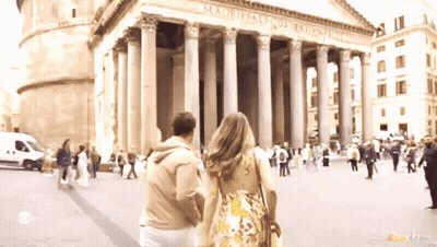 Man And Woman Walking In Front Of Magrippale Fort Templar GIF