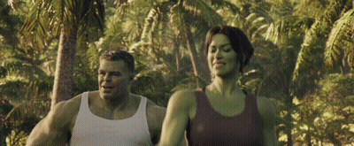 Man And Woman Walking In Lush Green Forest GIF