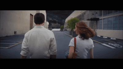 Man And Woman Walking Past No Parking Sign GIF