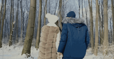 Man And Woman Walking Through Snow GIF
