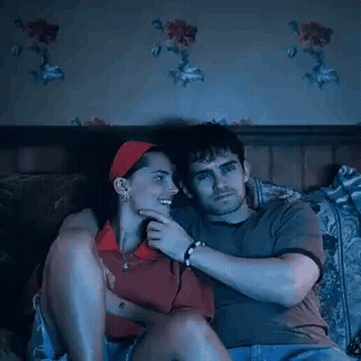 Man And Woman Watching Movie On Couch GIF
