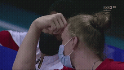 Man And Woman Wearing Face Masks Watching TVP 2 HD GIF