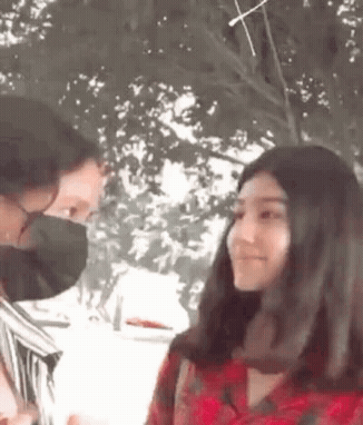 Man And Woman Wearing Masks Talking GIF