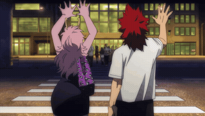 Man And Woman With Arms Up In Front Of Building GIF
