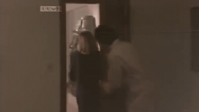 Man And Woman With Blinds Covering Faces GIF