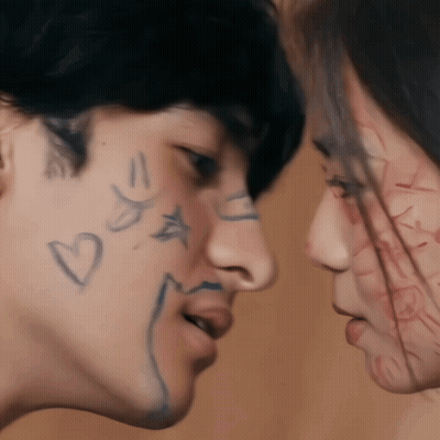 Man And Woman With Hearts And Stars On Faces GIF
