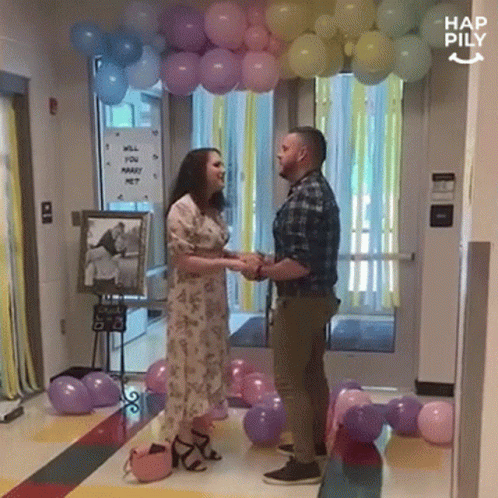 Man And Woman With Marry Me Sign GIF