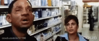 Man And Woman With Mouths Open In Store GIF