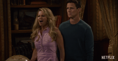 Man And Woman With Netflix Logo GIF