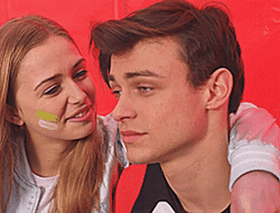 Man And Woman With Painted Faces Looking At Each Other GIF