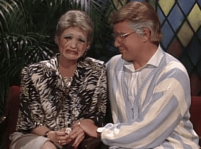 Man And Woman With Painted Faces On Couch GIF