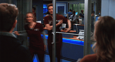Man And Woman With Stethoscope In Front Of Glass Door GIF