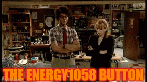Man And Woman With The Energy 1058 Button Behind Them GIF