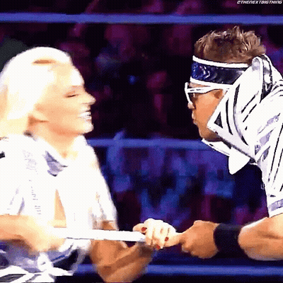 Man And Woman Wrestling In Ring Woman With Headband And Sunglasses GIF