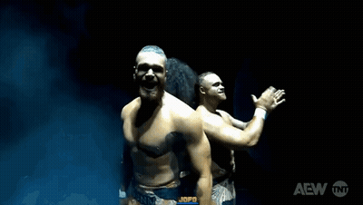 Man and Woman Wrestling in Water With AEW Logo