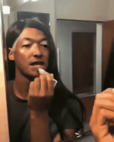 Man Applying Lipstick In Mirror GIF