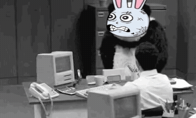 Man At Computer With Cartoon Bunny On Head GIF
