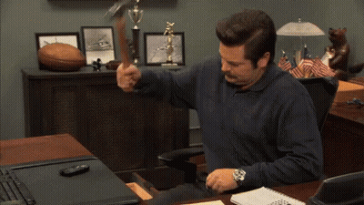 Man At Desk Holding Hammer GIF