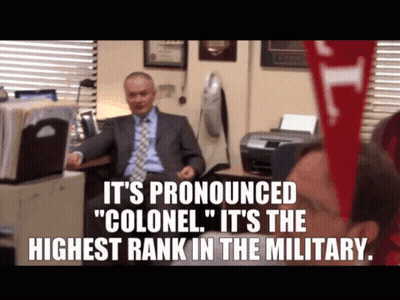 Man At Desk Saying It's Pronounced Colonel GIF