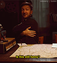 Man At Desk With Arms Crossed Says Is This Still Funny GIF