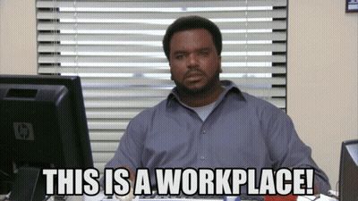 Man at Desk With Computer Saying This Is A Workplace