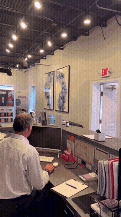 Man At Desk With Exit Sign GIF
