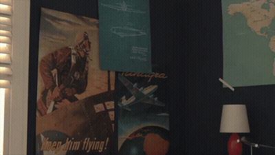 Man At Desk With Globe And Picture Frame GIF