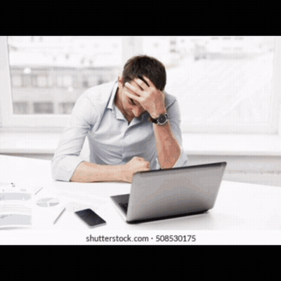 Man At Desk With Hands On Head In Front Of Laptop GIF
