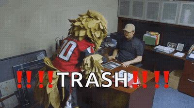 Man At Desk With Mascot Saying Trash GIF