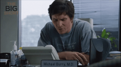 Man At Desk With Michael Burry M.D. Sign GIF
