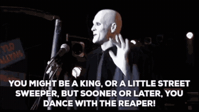 Man At Microphone In Dark Room With Crowd GIF