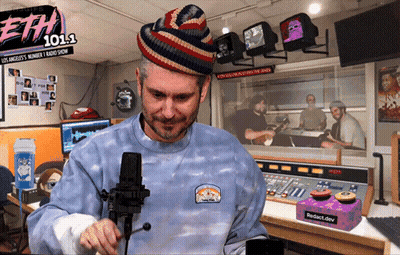 Man At Microphone In Front Of ETH 101.1 Sign GIF