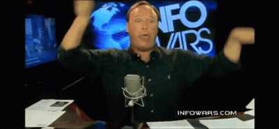 Man At Microphone In Front Of Info Wars Screen GIF