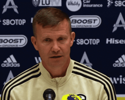 Man At Microphone In Front Of Sbotop Sign GIF
