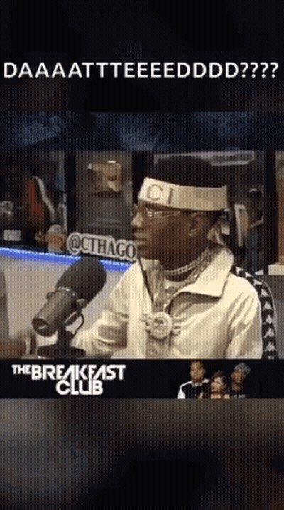 Man at Microphone Wearing Gucci Headband