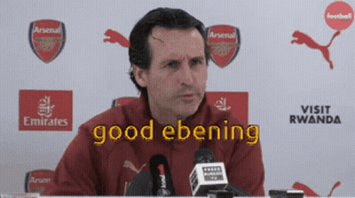 Man At Microphone With Good Ebening On Screen GIF