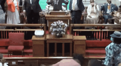 Man At Podium Facing Church Crowd GIF
